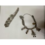 TWO SILVER BRACELETS TO INCLUDE A CHARM BRACELET WITH FIVE CHARMS AND A FIVE BAR GATE BRACELET