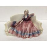 A KAZHUTTE PORCELAIN FIGURINE OF A LADY ON A CHAIR