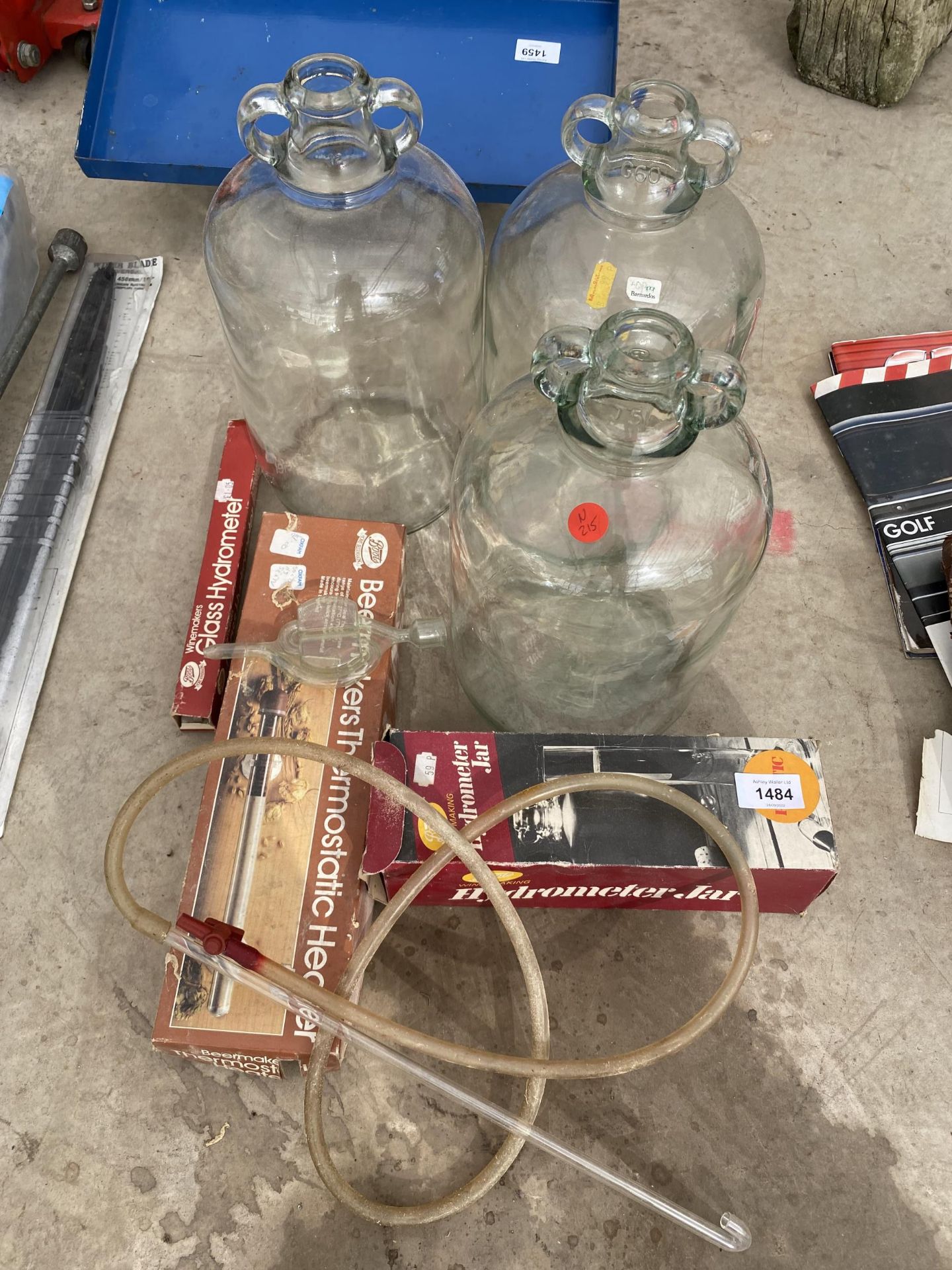 AN ASSORTMENT OF BREWING EQUIPMENT TO INCLUDE THREE DEMI JOHNS, A GLASS HYDROMETER AND A