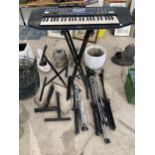 A YAMAHA ELECTRIC KEYBOARD ON A STAND AND VARIOUS MUSIC STANDS