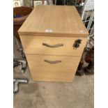 A WOODEN TWO DRAWER FILING CABINET