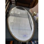 A BRASS FRAMED BEVELED EDGE WALL MIRROR