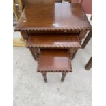 A NEST OF THREE HARDWOOD TABLES WITH ROPE EDGES ON TURNED AND FLUTED LEGS