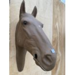 A BROWN PLASTIC HORSES HEAD