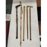 FIVE WALKING STICKS TO INCLUDE A BRASS HEADED DOG AND HORSE, ONE WITH TOURIST BADGES, ETC