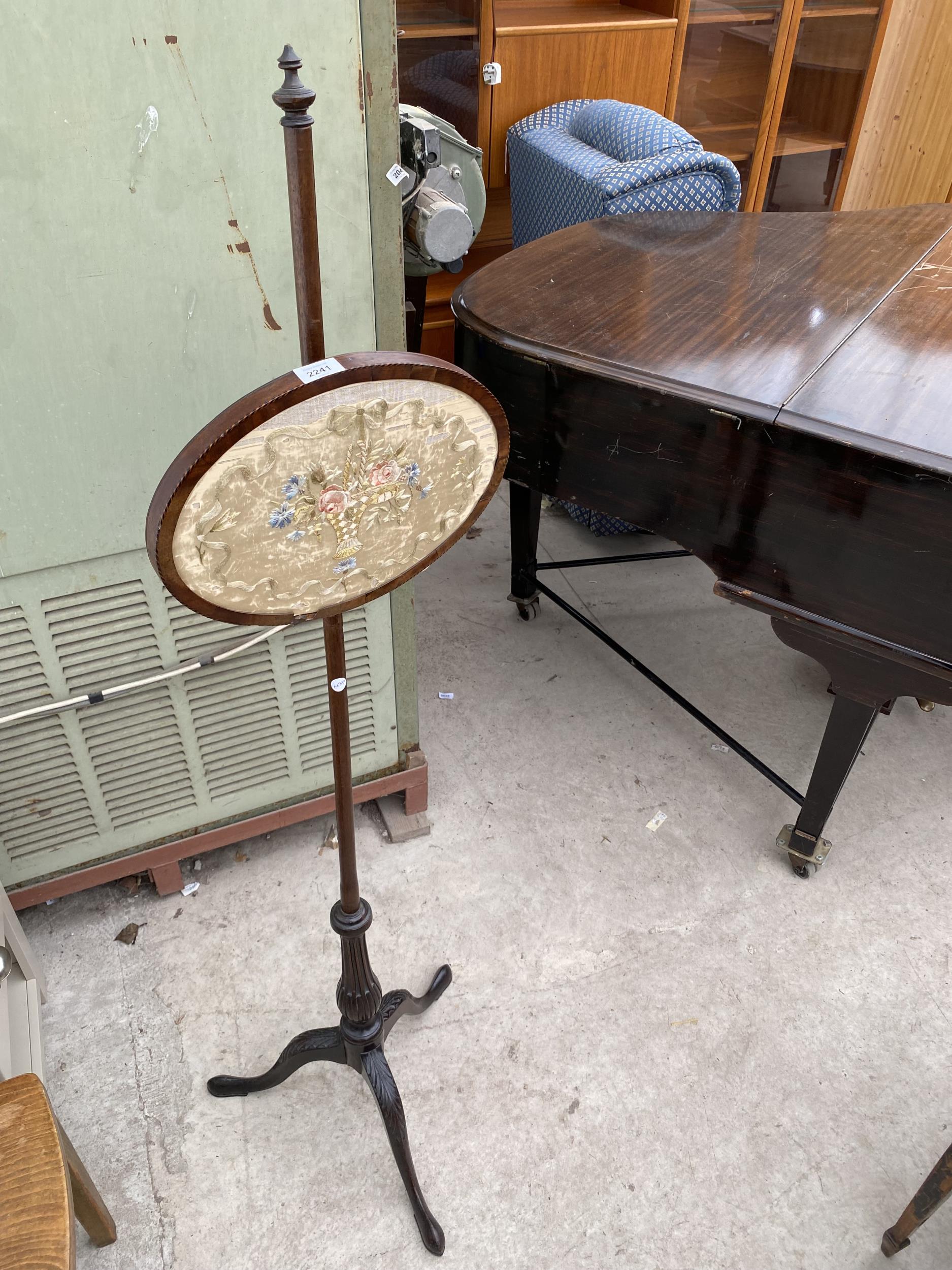 A VICTORIAN MAHOGANY POLE SCREEN WITH OVAL SILKWORK PANEL AND TRIPOD BASE