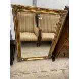 A MODERN GILT FRAMED WALL MIRROR 41.5" X 30"