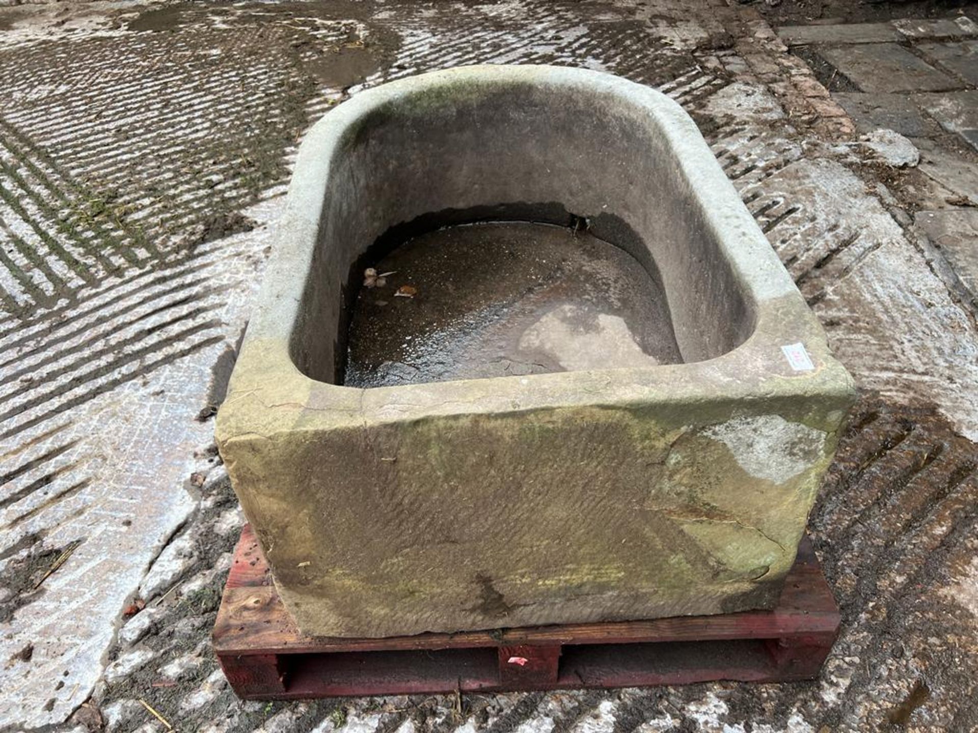 A STONE PUMP TROUGH APPROX 4' LONG WITH A CRACK AT ONE END (ON A PALLET) + VAT