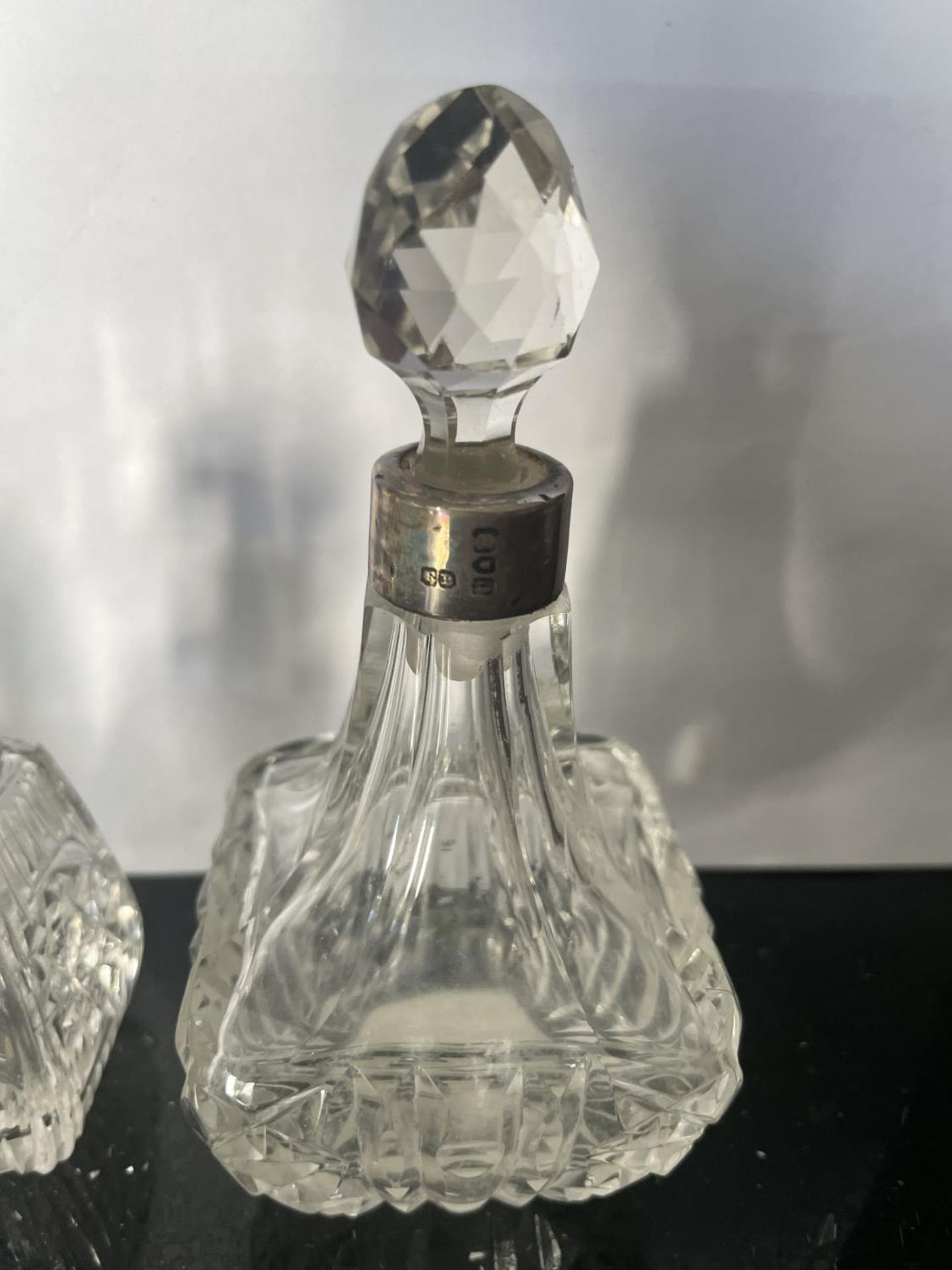 THREE CUT GLASS PERFUME BOTTLE WITH HALLMARKED LONDON SILVER COLLARS - Image 4 of 4