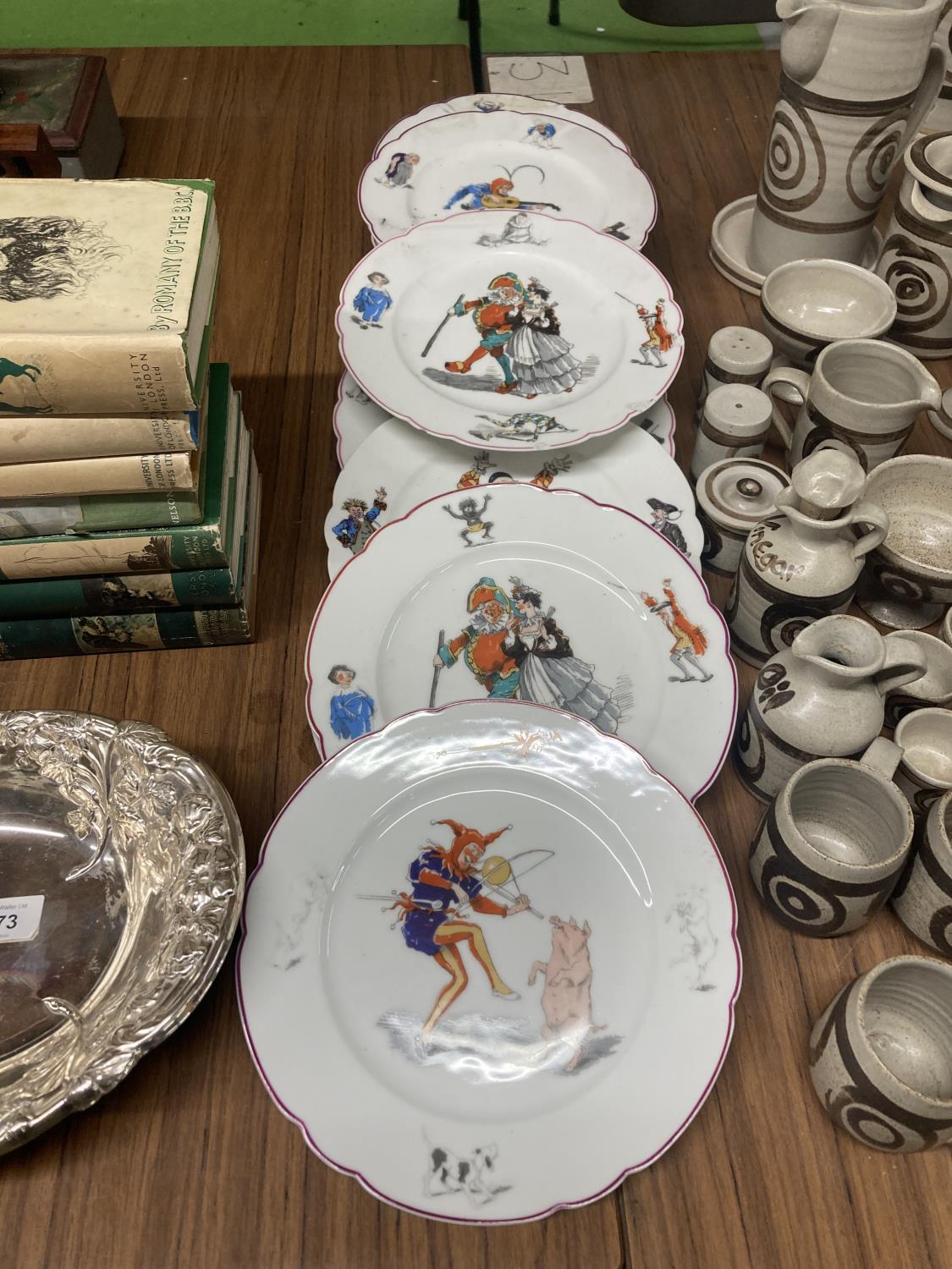 A COLLECTION OF VINTAGE PLATES WITH IMAGES OF COMICAL JESTER SCENES