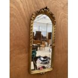 A DECORATIVE GILT FRAMED WALL MIRROR WITH FLORAL DETAIL