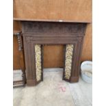 A VICTORIAN CAST IRON FIREPLACE WITH MANTLE SHELF AND FLORAL TILED SURROUND (H:119CM W:121CM)