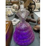 A GLASS DECANTER IN THE SHAPE OF A COBRA FILLED WITH PURPLE WATER (NOT FOR DRINKING)