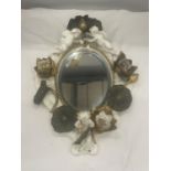 A WHITE AND GILDED CERAMIC MIRROR WITH CHERUB, LILY AND LEAF DESIGN (A/F CHERUBS ARM)