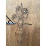 A BENT METAL WALL HANGING OF A VASE OF FLOWERS