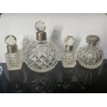 FOUR CUT GLASS PERFUME BOTTLES WITH HALLMARKED BIRMINGHAM SILVER COLLARS AND TOP