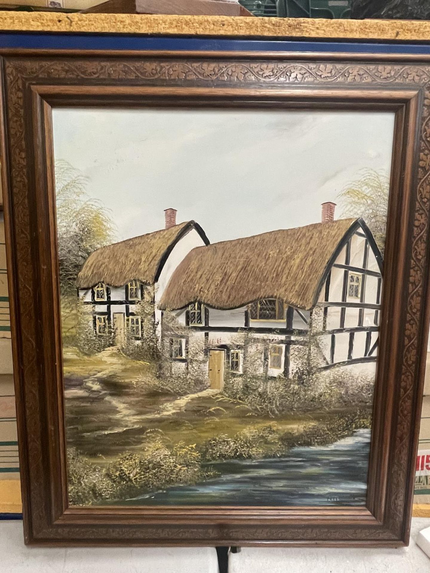A FRAMED OIL ON CANVAS OF A COUNTRY COTTAGE SIGNED PR FREEMAN