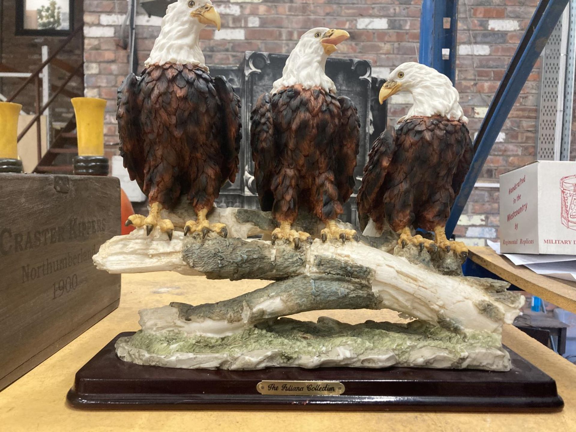 A RESIN MODEL OF A GROUP OF THREE BALD EAGLES ON A BRANCH BY THE JULIANA COLLECTION HEIGHT 29CM,