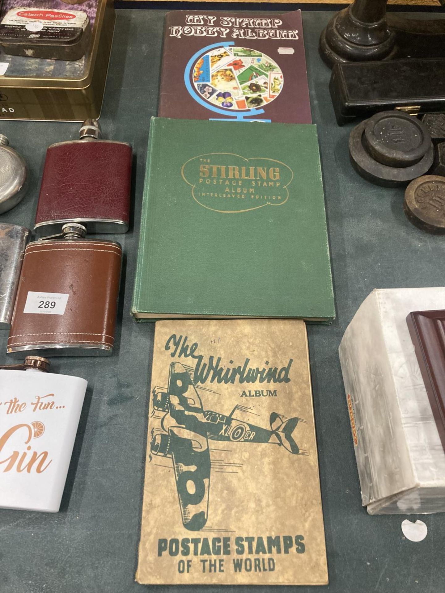 THREE VINTAGE STAMP ALBUMS WITH A VARIETY OF STAMPS