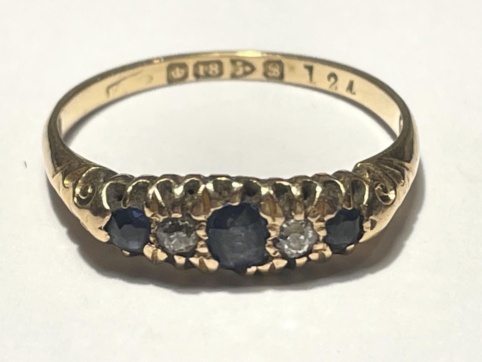 AN 18 CARAT GOLD RING WITH THREE IN LINE SAPPHIRES AND TWO DIAMONDS SIZE U/T GROSS WEIGHT 3.24 GRAMS