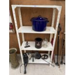 A FOUR TIER METAL SHELVING UNIT WITH CONTENTS TO INCLUDE A COOKING POT, HORSE SHOES AND AN OIL