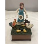 A VINTAGE STYLE CAST MONEY BANK OF A LADY FEEDING CHICKENS, TURN THE HANDLE AND 'OLD McDONALD HAD
