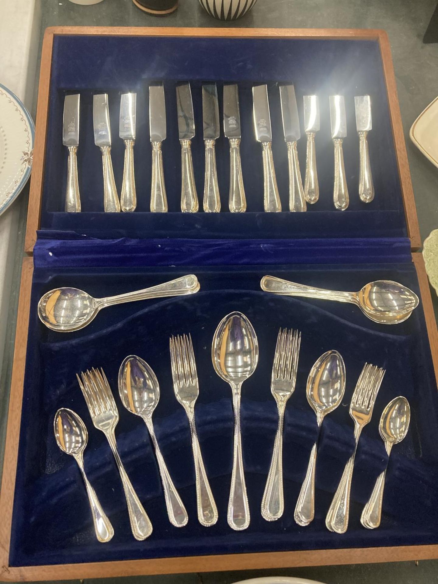 A CANTEEN OF CUTLERY IN A TEAK BOX