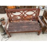 A WOODEN SLATTED GARDEN BENCH