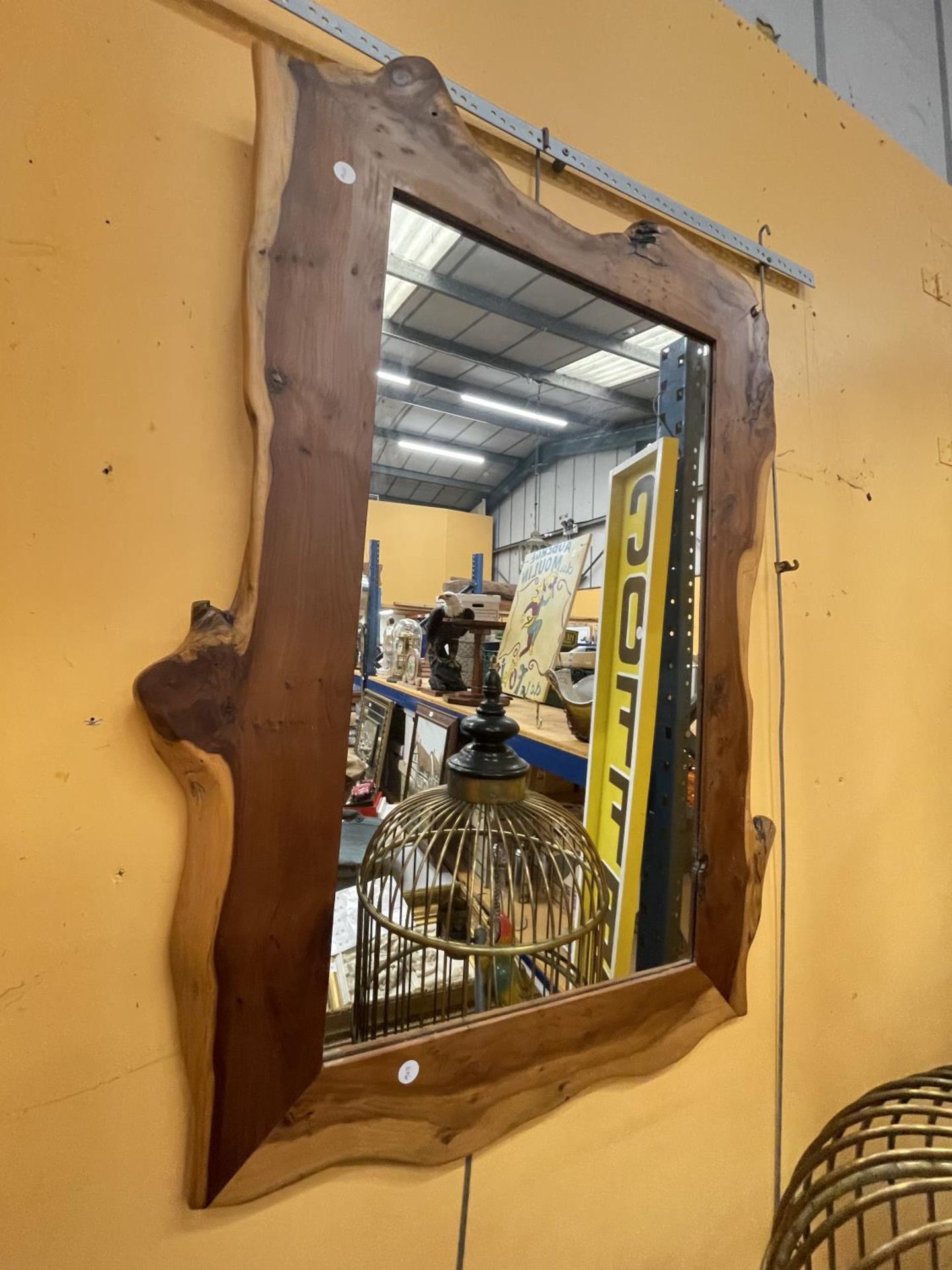 A LARGE PINE FRAMED MIRROR APPROXIMATELY 106CM X 70CM