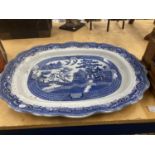 A LARGE, HEAVY BLUE AND WHITE WILLOW PATTERN PLATTER