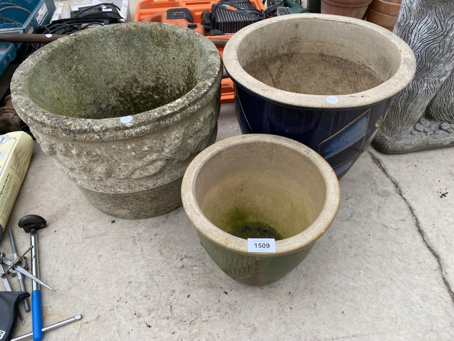 A RECONSTITUTED STONE GARDEN PLANTER AND TWO GLAZED PLANTERS