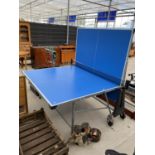 A LARGE FOLDING TABLE TENNIS TABLE