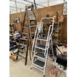 A TUBULAR METAL SET OF STEP LADDERS AND TWO VINTAGE WOODEN STEP LADDERS