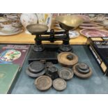 A VINTAGE SET OF CAST SCALES WITH BRASS PANS PLUS A QUANTITY OF WEIGHTS