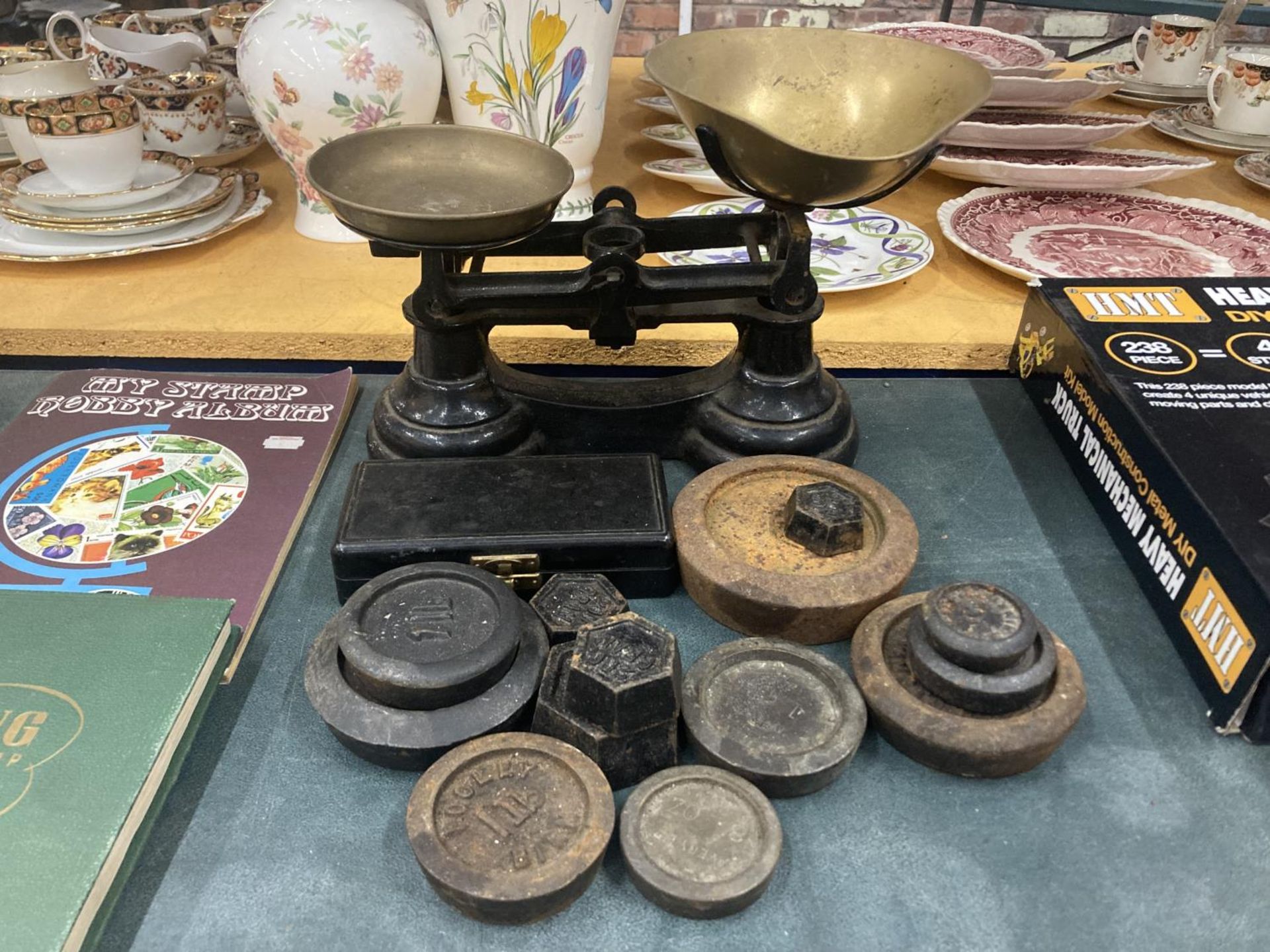 A VINTAGE SET OF CAST SCALES WITH BRASS PANS PLUS A QUANTITY OF WEIGHTS