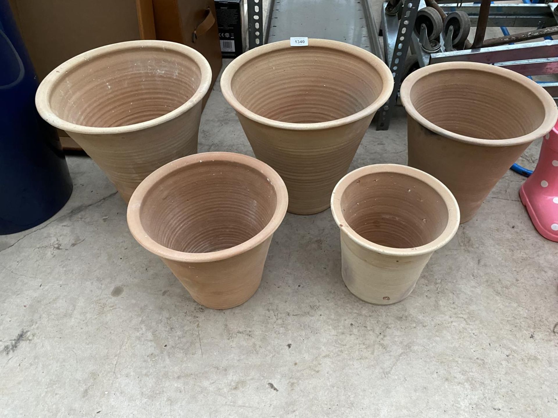 A SET OF FIVE AS NEW GRADUATED TERRACOTTA PLANTERS