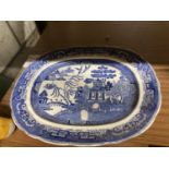 A LARGE VICTORIAN BLUE AND WHITE WILLOW PATTERN PLATTER 56CM X 47CM