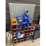 A WORKSHOP DISPLAY BOARD WITH A LARGE ASSORTMENT OF LIN BINS CONTAINING HARDWARE AND TOOLS ETC