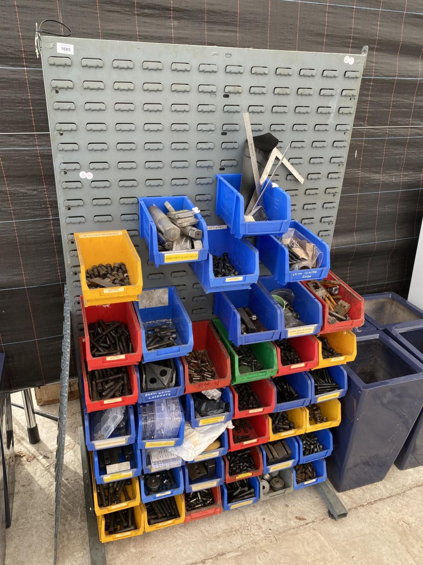 A WORKSHOP DISPLAY BOARD WITH A LARGE ASSORTMENT OF LIN BINS CONTAINING HARDWARE AND TOOLS ETC