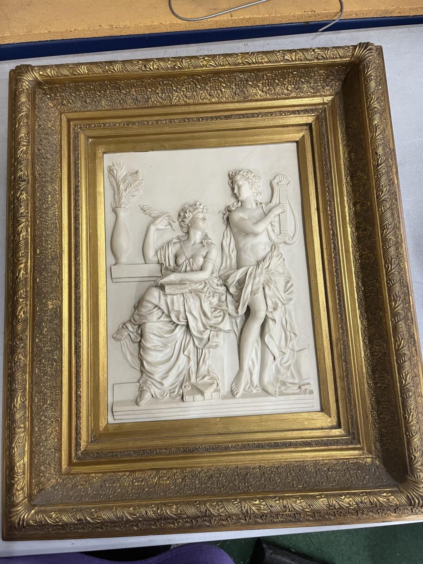 A HAEVY CARVED PLAQUE OF GREEK GODDESSES IN AN ORNATE GILT FRAMED 67CM X 58CM