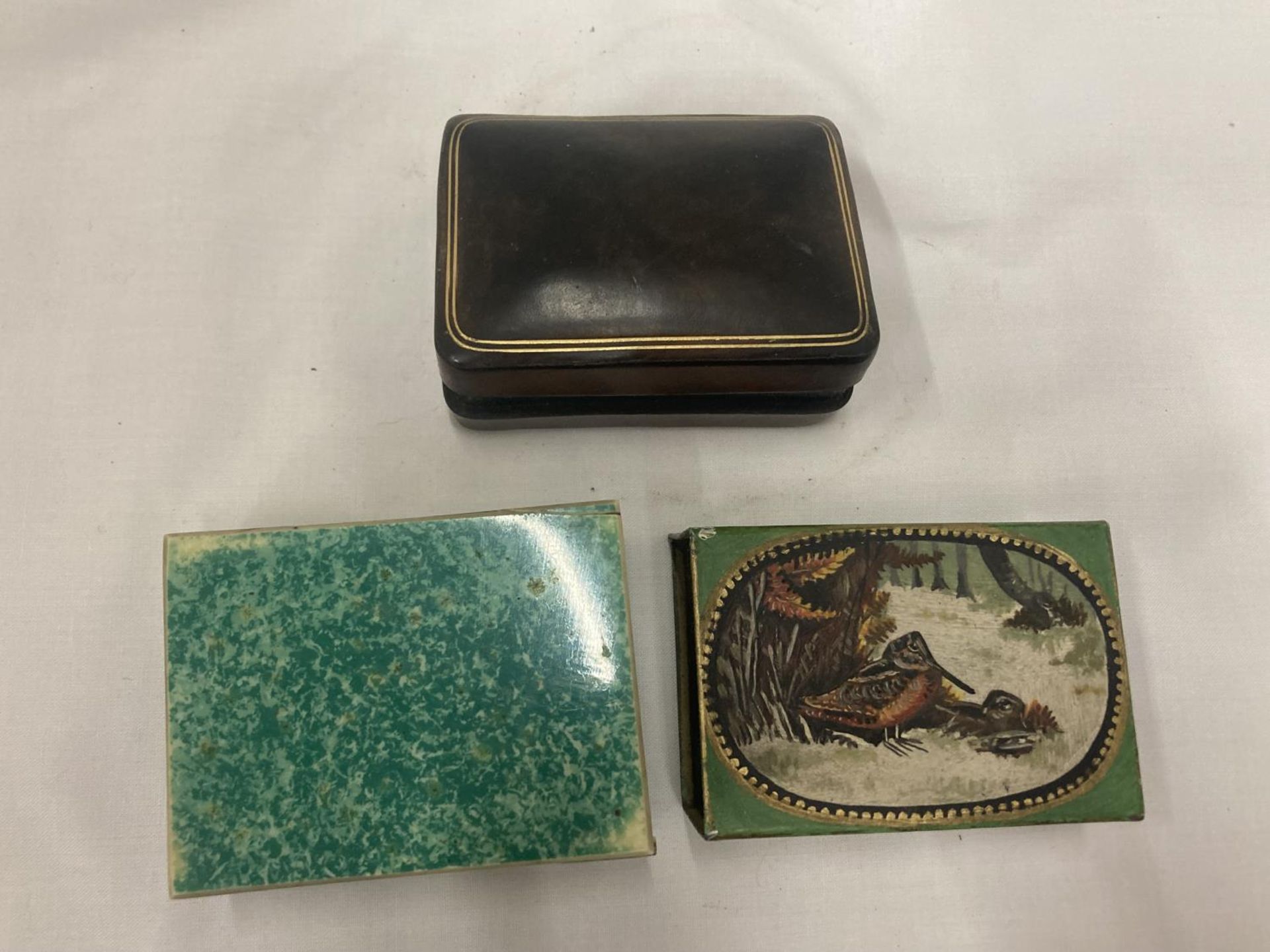 TWO VINTAGE MATCHBOX COVERS AND A TREEN CIGARETTE BOX WITH INLAY TO THE TOP