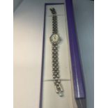 A SILVER WRIST WATCH WITH A PEARLISED FACE SEEN WORKING BUT NO WARRANTY