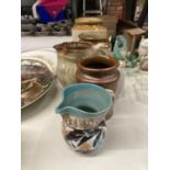 A COLLECTION OF STONEWARE ITEMS TO INCLUDE STORAGE JARS AND JUGS