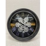 A WALL CLOCK WITH MOVING COGS ON THE FACE DIAMETER 33CM