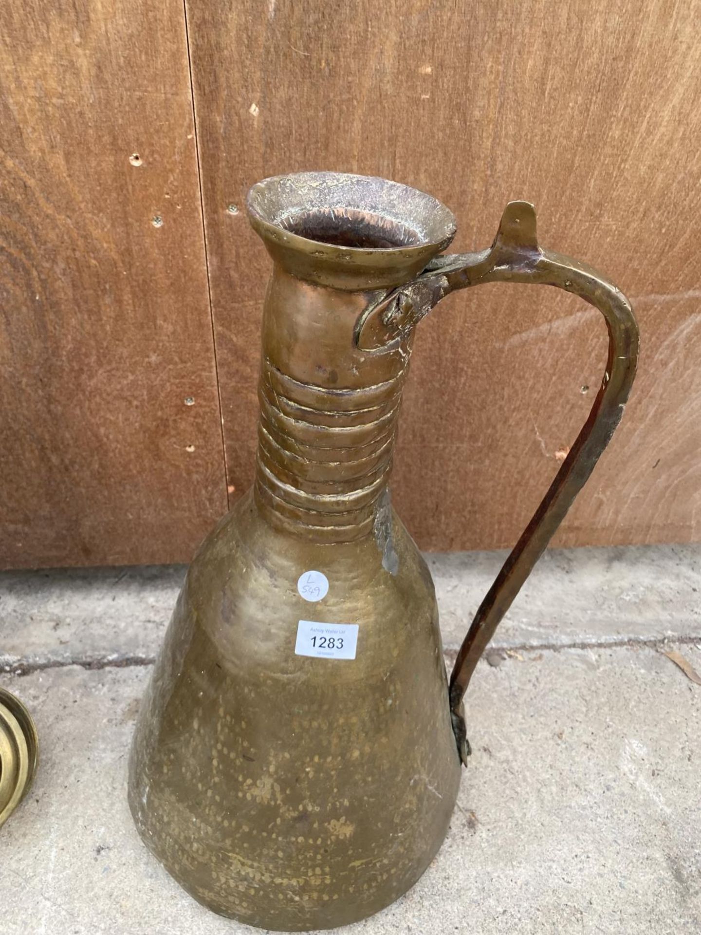 A LARGE MIDDLE EASTERN STYLE COPPER JUG