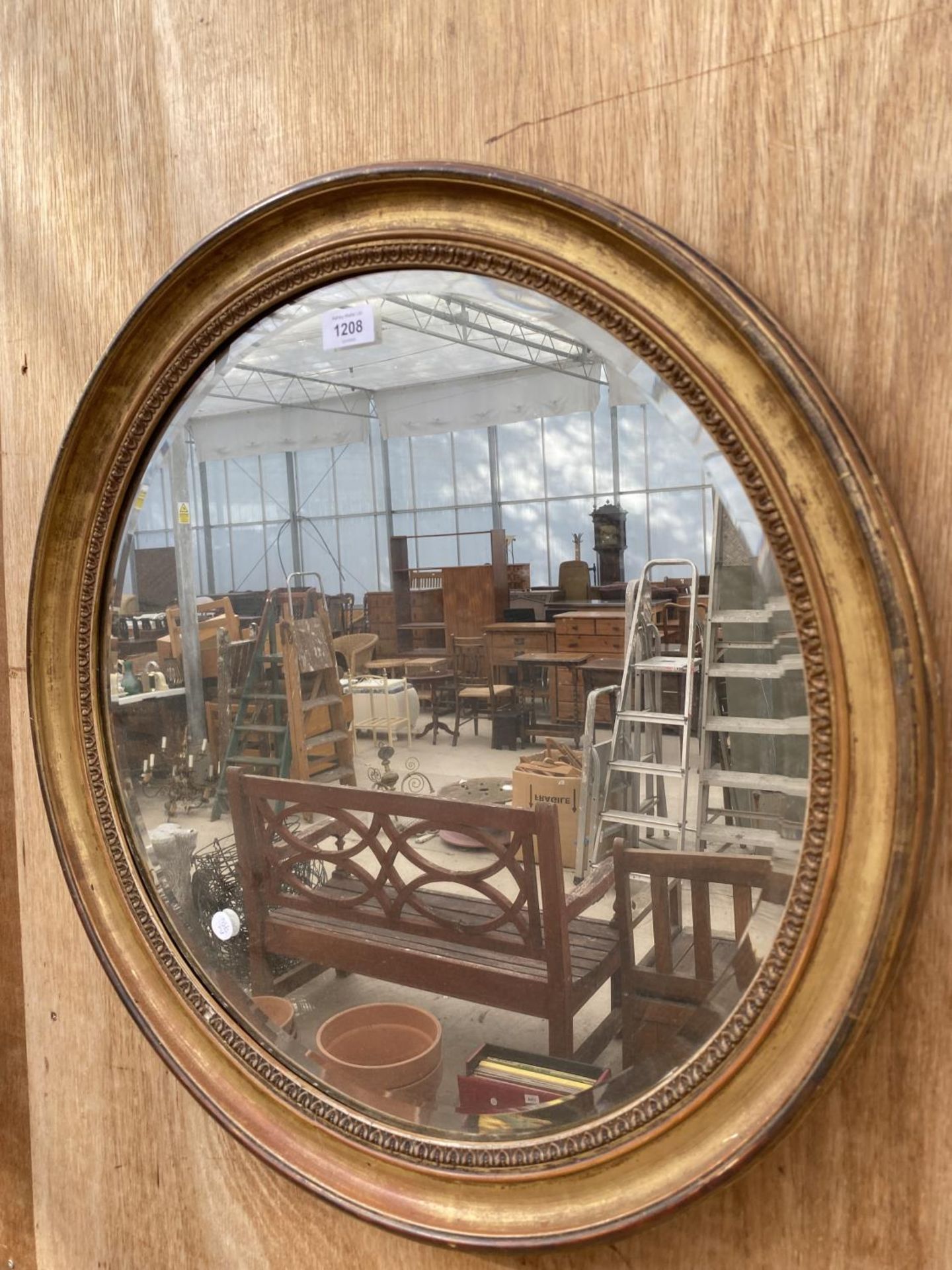 A GILT FRAMED CIRCULAR BEVELED EDGE WALL MIRROR