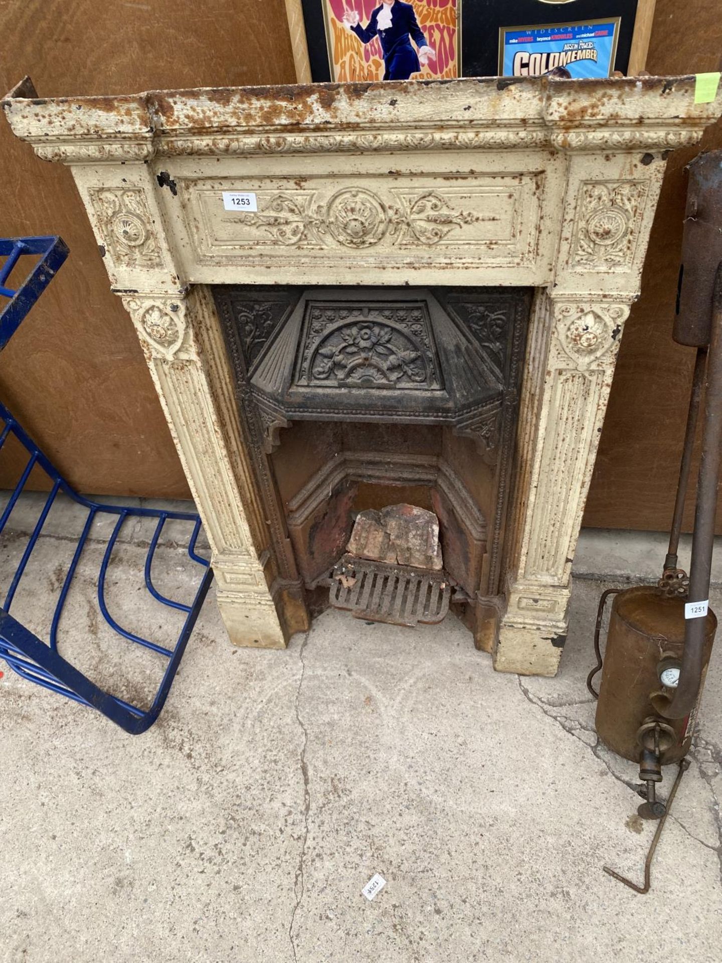 A VINTAGE CAST IRON FIRE PLACE WITH GRATE