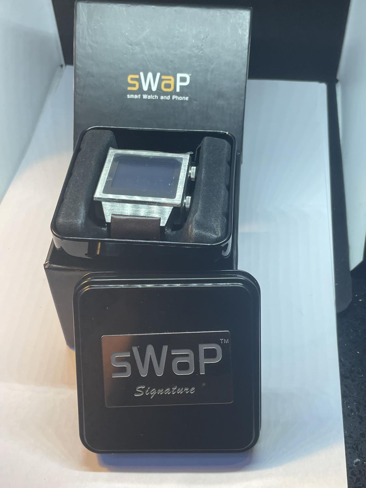 A SWAP SMART WATCH IN PRESENTATION TIN AND BOX