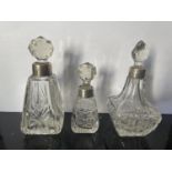 THREE CUT GLASS PERFUME BOTTLE WITH HALLMARKED LONDON SILVER COLLARS