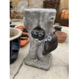 A RECONSTITUTED STONE TREE STUMP PEDESTAL BASE